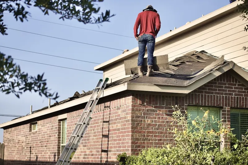 Professional roofer working on a residential roof in The Woods of Marlton